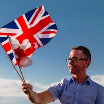 Highclere Castle - 03 August 2013 / I just love this photo of this guy waving proudly his flags